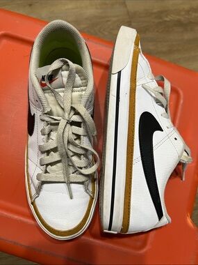 Nike White Sneakers with Black Swoosh and Mustard Accent